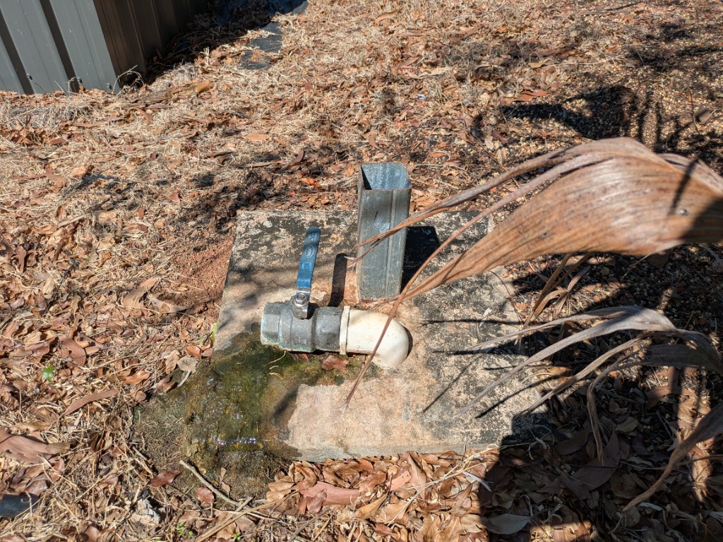 Flush-out valve at the end of the western main, between units #79 and #80