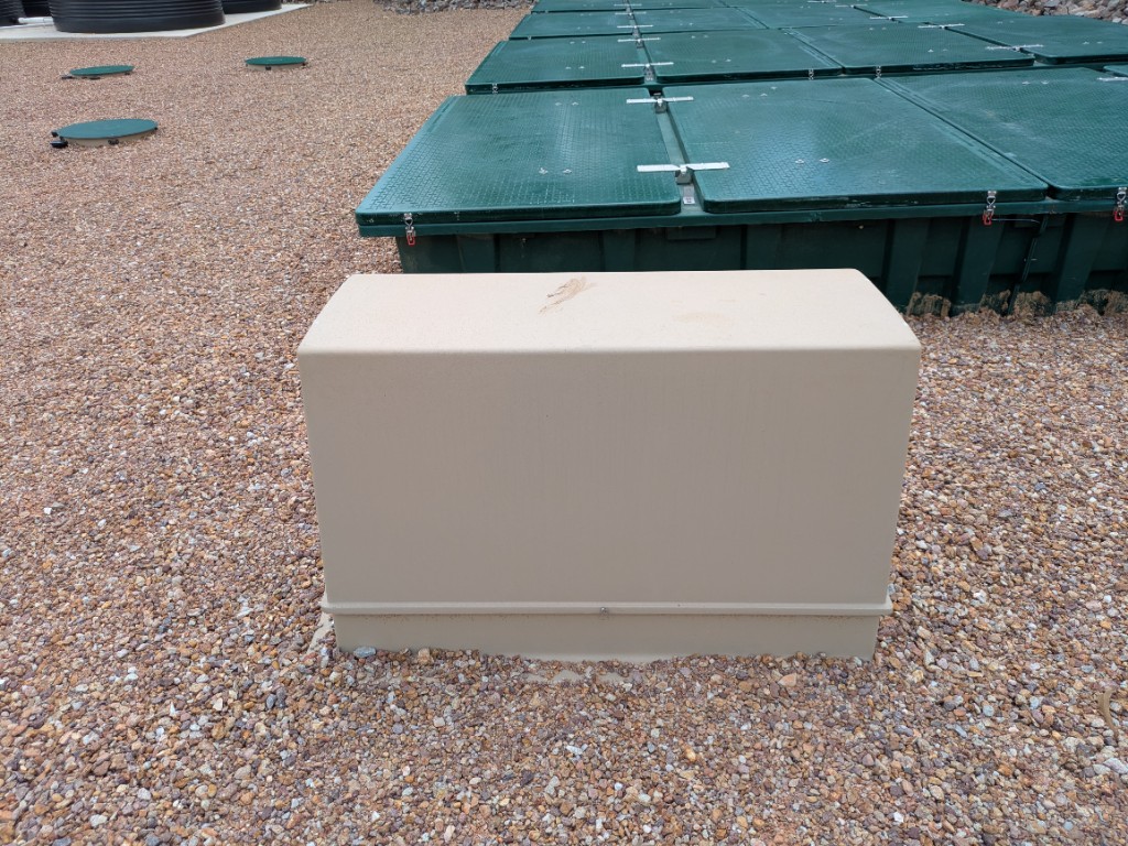 AX100 ventilation fan and filter enclosure in front of the textile filter pods