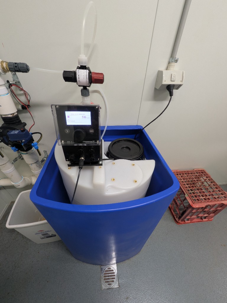 Grundfos SMART Digital chlorine dosing pump and tank in the WWTP control room