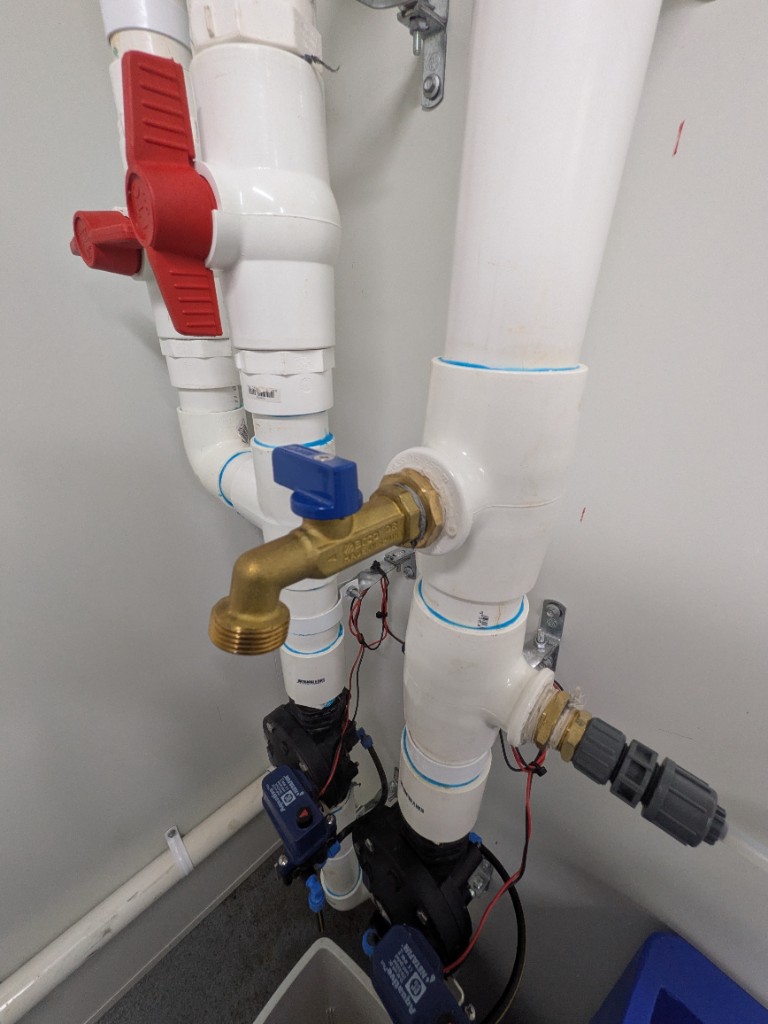 Sampling tap on the treated-effluent manifold in the WWTP control room